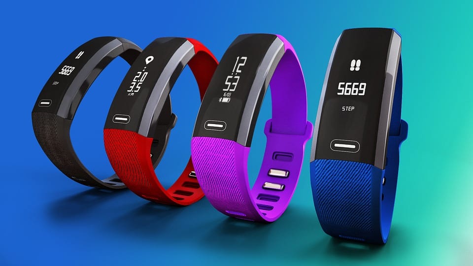 Image of classic fitness trackers like the FitBit in different colors